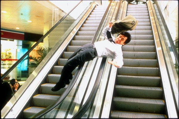 Jackie Chan in Chinese Zodiac sliding down an escalator railing